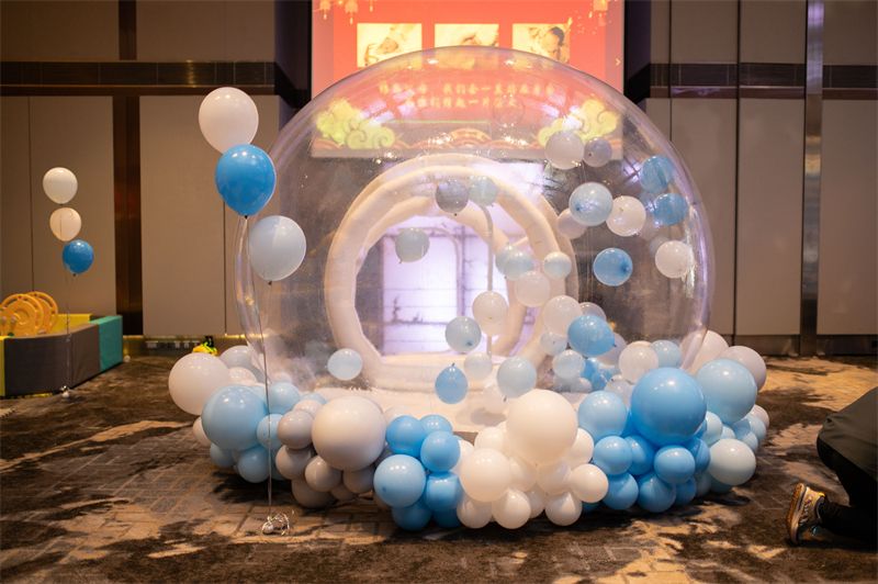 Bubble house decorated with blue and white balloons