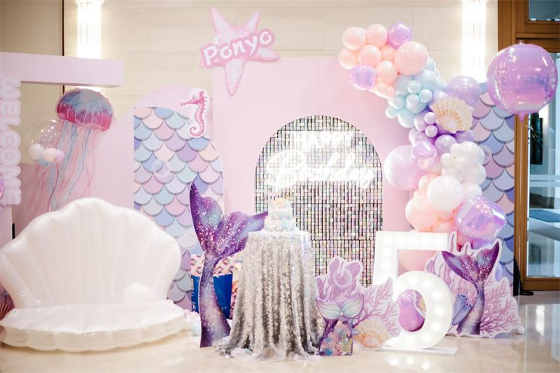 Pastel mermaid themed birthday backdrop with balloons