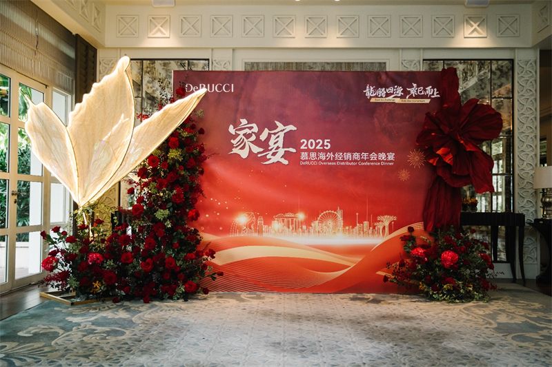 Red and gold corporate dinner backdrop with flowers