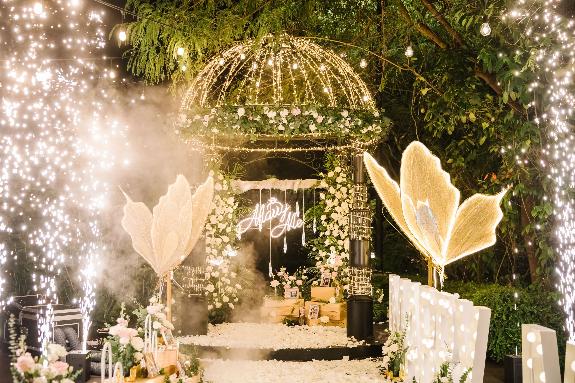 Garden gazebo lit with fairy lights and sparklers for a proposal