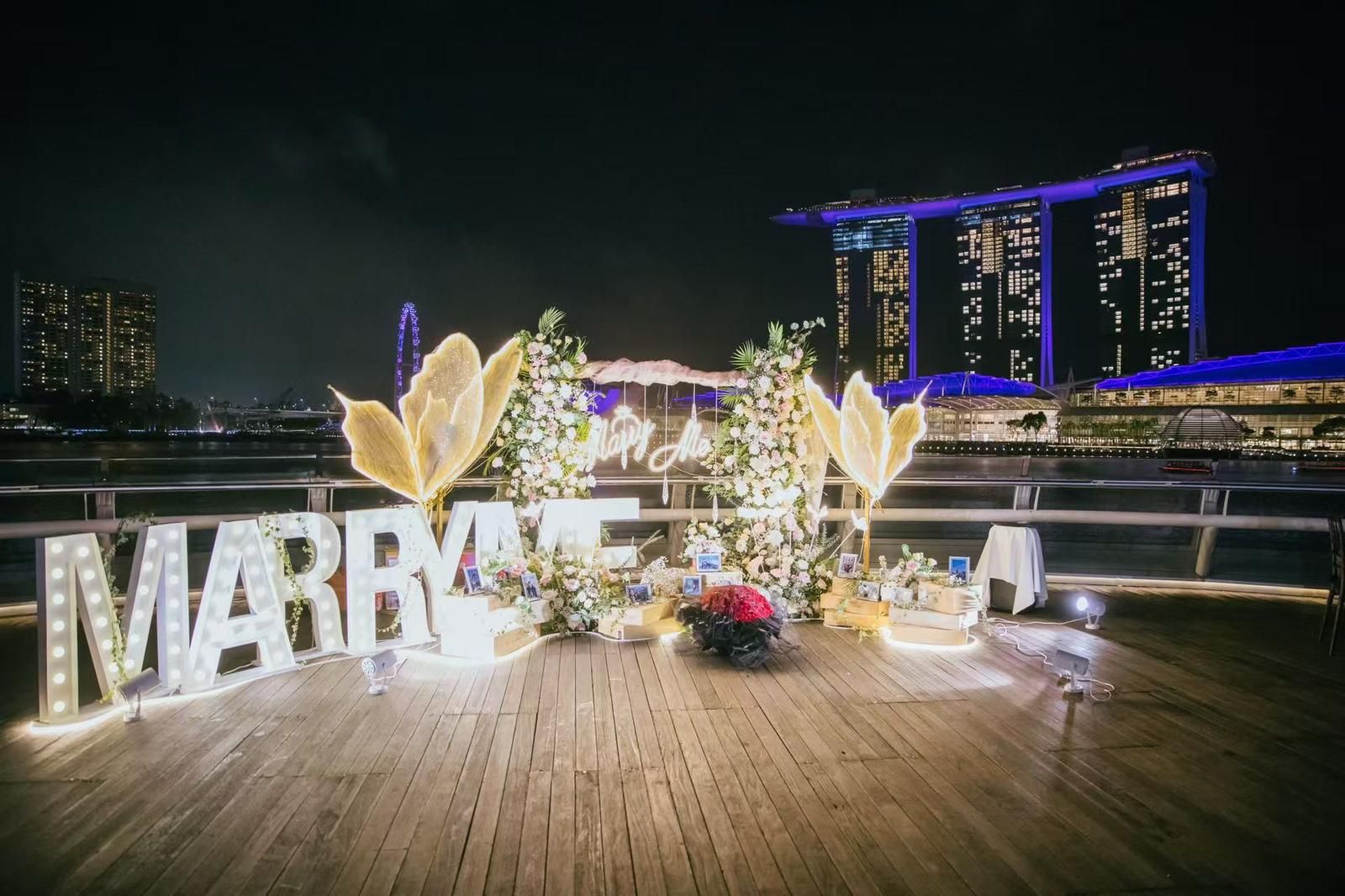 Marry Me letters lit up at night with Marina Bay Sands behind