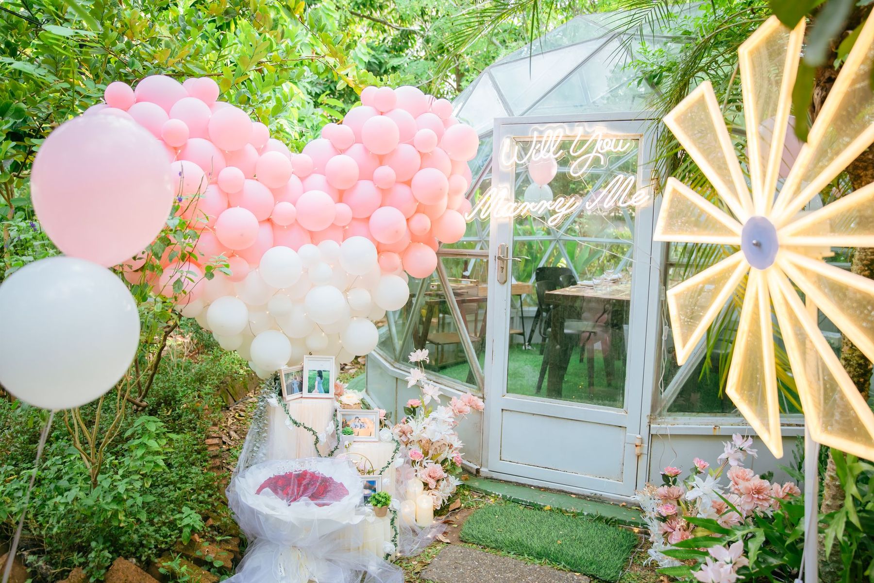 Pink balloon heart outside a glass garden dome