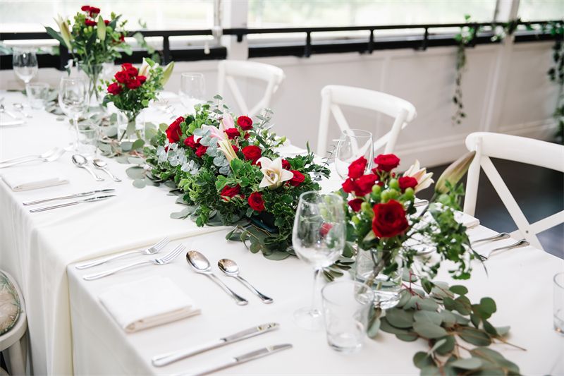 Long table with red roses and candles